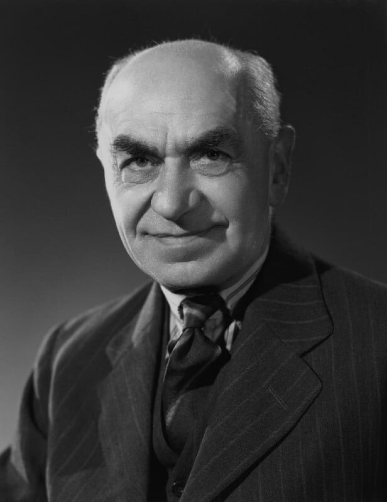 Black-and-white 1948 studio portrait of psychologist Frederic Bartlett in a pinstriped suit.