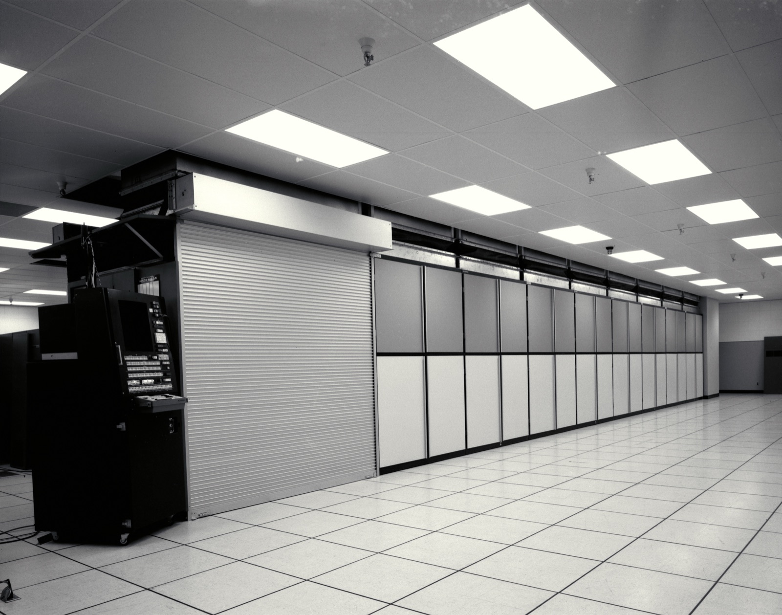 A long row of ILLIAC IV parallel-processor cabinets stretching across a computer room at NASA Ames, photographed in black and white in 1972.