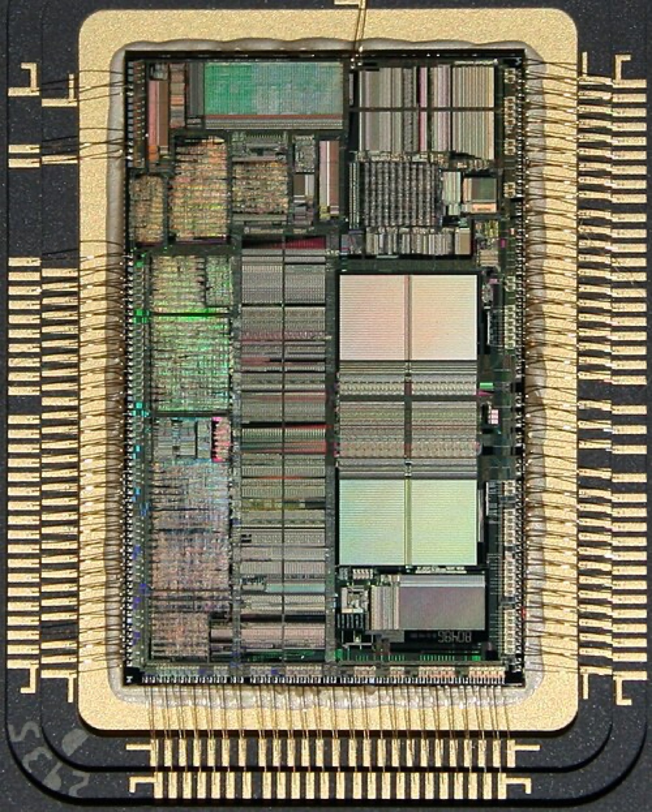 Macro photograph of an opened Intel 80486 microprocessor package showing the die and its bond wires, ca. 1990.